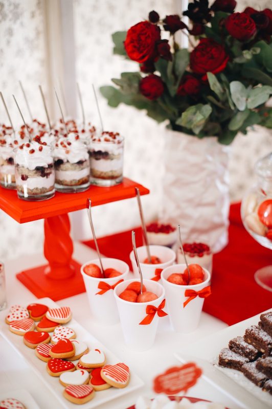themed candy bar for wedding party in red and white colors with hearts